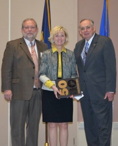 Radius Indiana President Becky Skillman received a history of the AOC after her remarks at the Industry Night reception. (left to right) AOC Crane Roost President Jim Hearn, Radius Indiana President/CEO Becky Skillman, Maj Gen Kenneth R. Israel, USAF (ret), AOC 2015 President